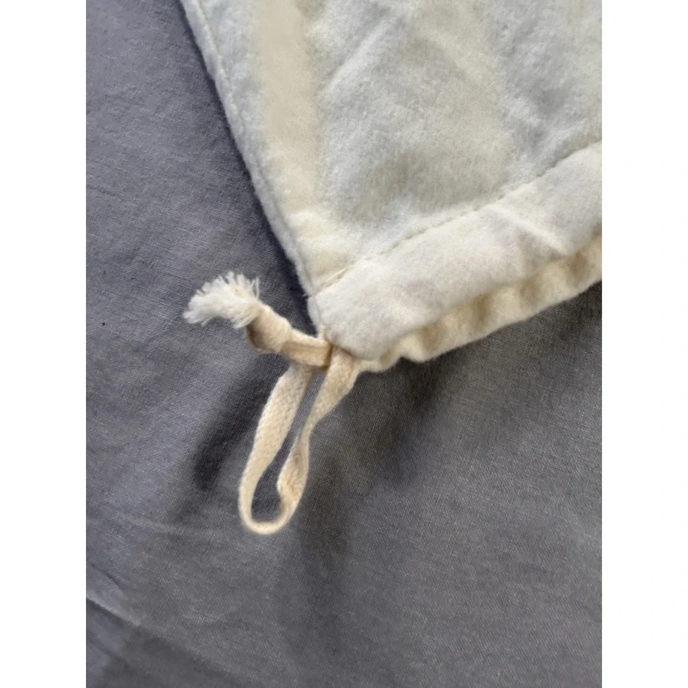 The Frye Company cream-colored cotton dust bag with‎ a drawstring closure boots